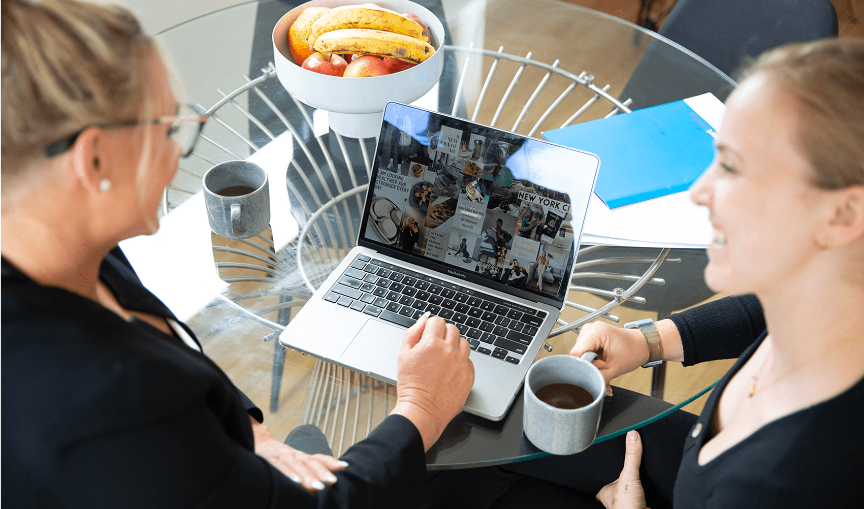 Smart Lending professionals discussing loan options over coffee at a modern workspace.